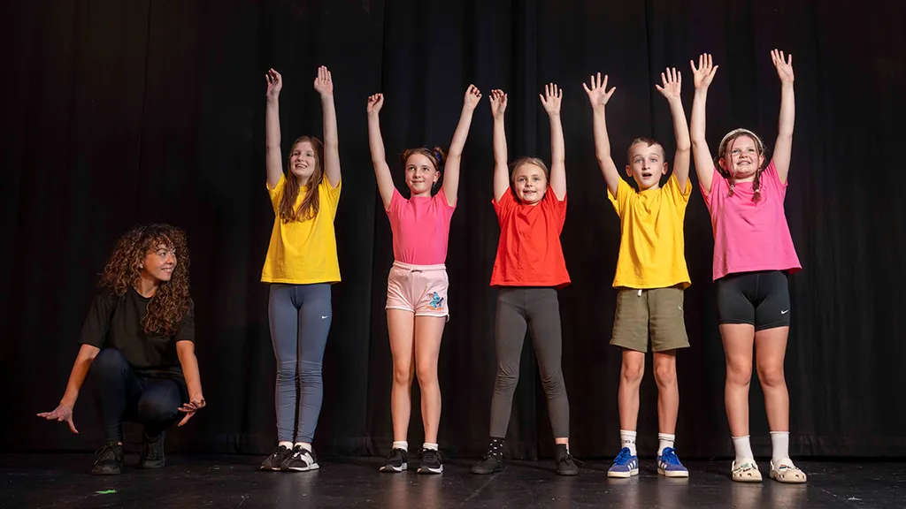 Primary age children taking part in a drama production