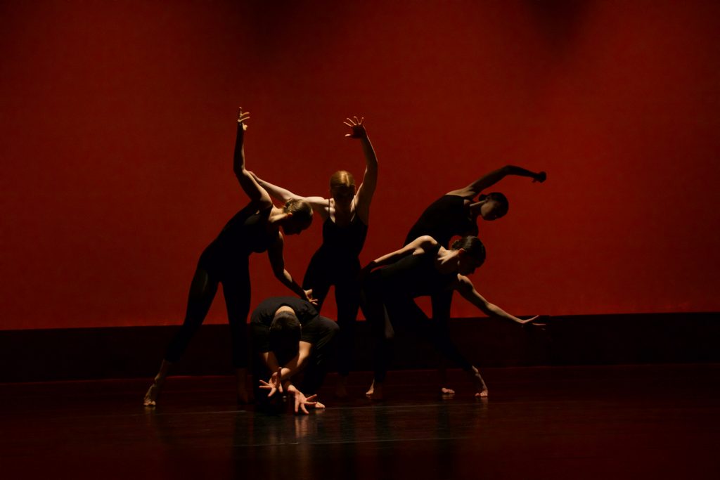 dancers in shadow on a stage